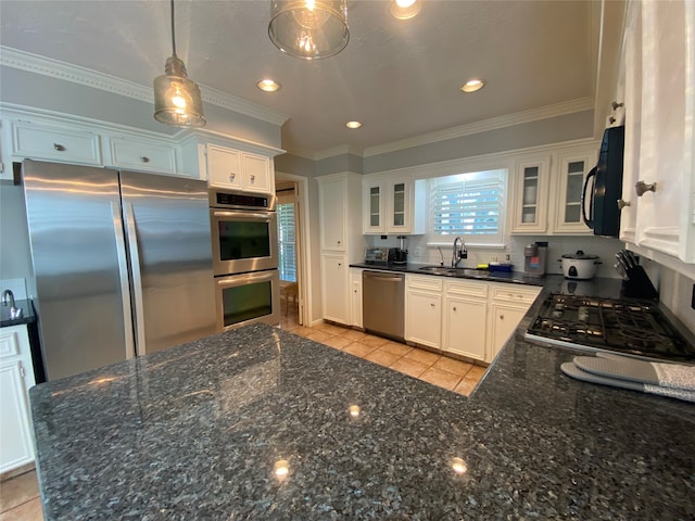 kitchen with white cabinets, appliances with stainless steel finishes, sink, crown molding, and decorative light fixtures