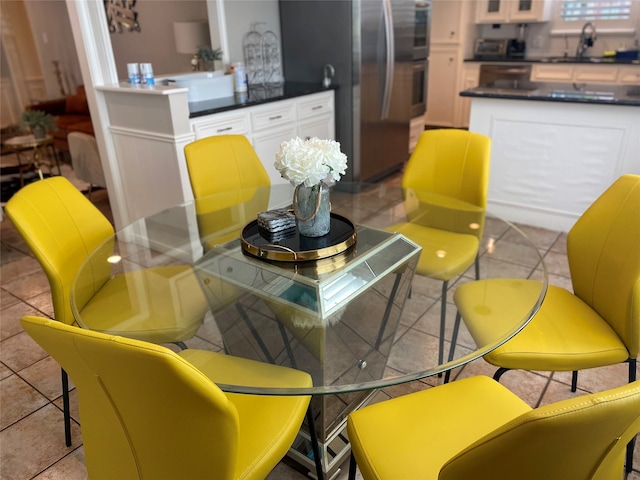 dining space with sink and light tile patterned floors