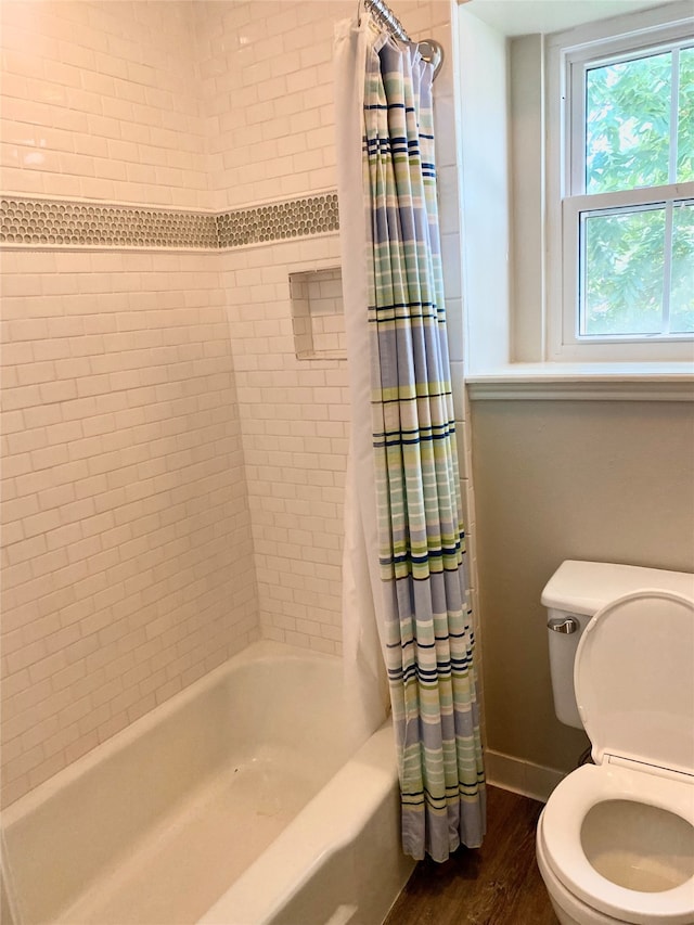 bathroom featuring shower / bath combination with curtain, toilet, and wood-type flooring