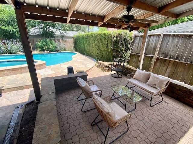 view of patio featuring ceiling fan and a pool with hot tub