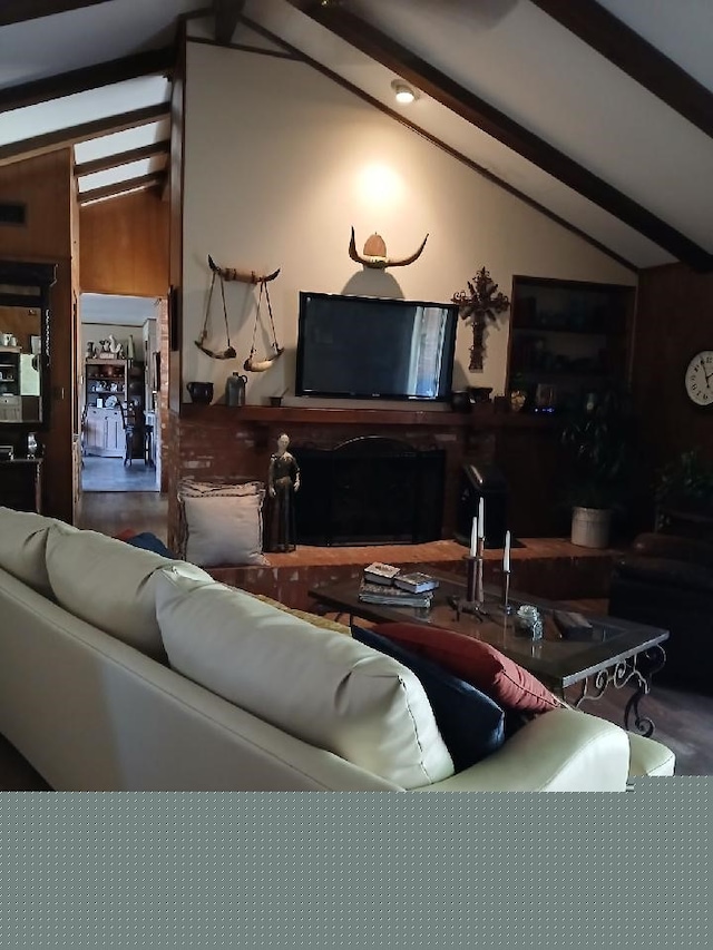 living room featuring vaulted ceiling with beams