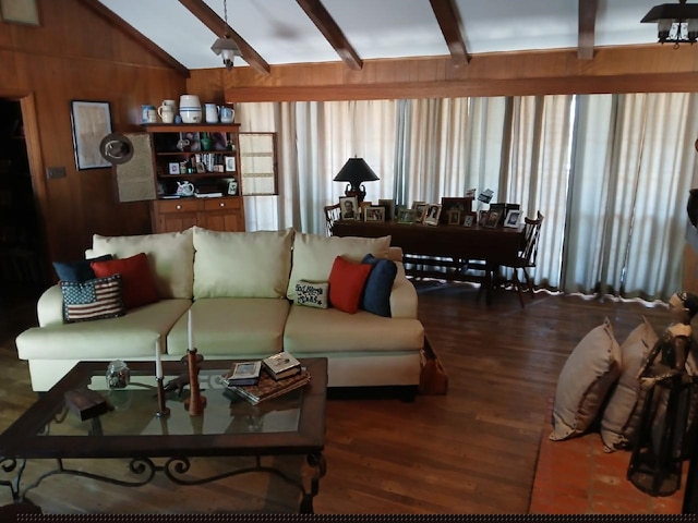 living room featuring wooden walls, lofted ceiling with beams, and dark wood-type flooring