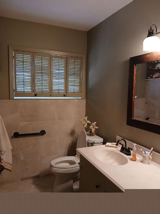 bathroom with vanity, tile patterned flooring, toilet, and tile walls