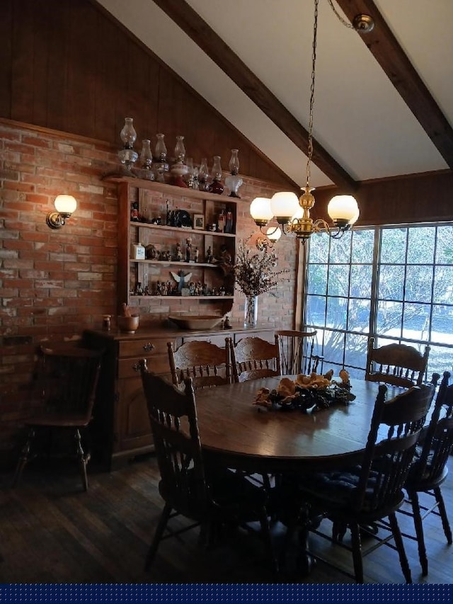 dining area with beam ceiling, an inviting chandelier, dark hardwood / wood-style floors, and brick wall