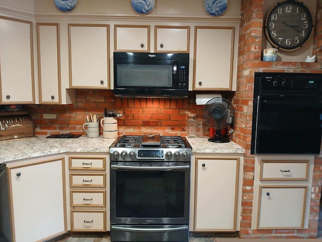 kitchen featuring black appliances and cream cabinetry