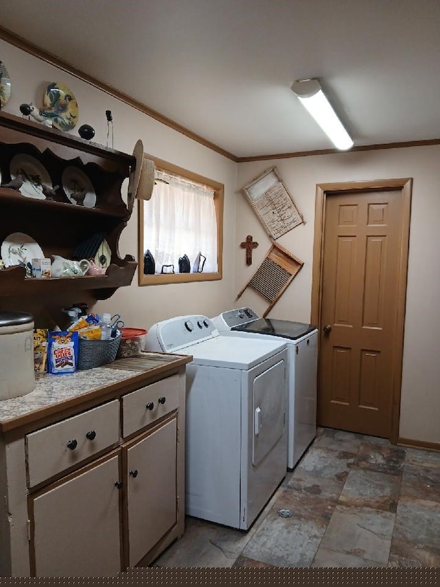 laundry area with cabinets, crown molding, and washer and dryer