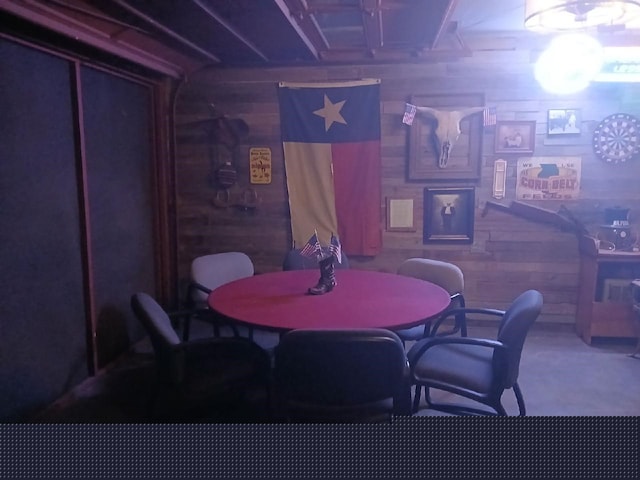 dining room featuring wooden walls