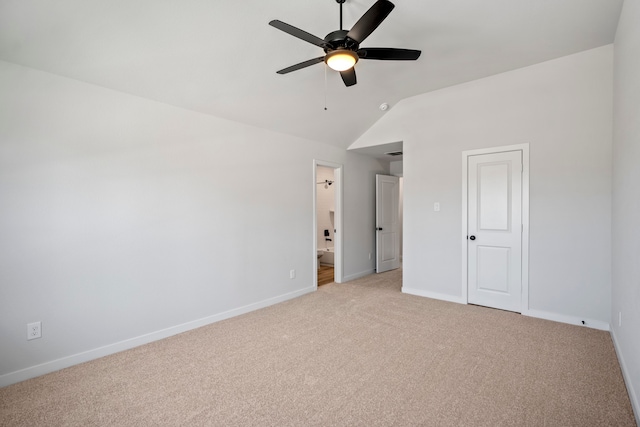 unfurnished bedroom with light carpet, lofted ceiling, ensuite bathroom, and ceiling fan