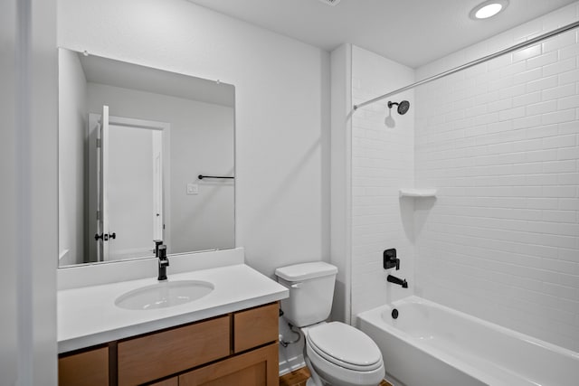 full bathroom with vanity, tiled shower / bath combo, and toilet