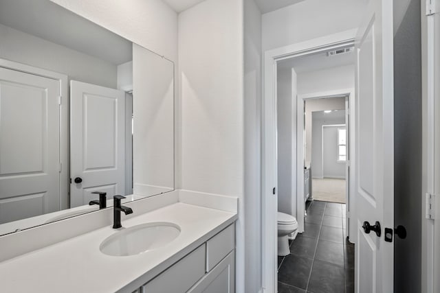 bathroom featuring vanity, toilet, and tile patterned floors