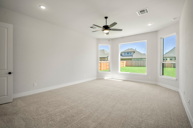 spare room featuring ceiling fan and carpet