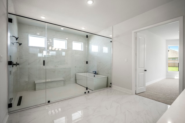 bathroom featuring shower with separate bathtub