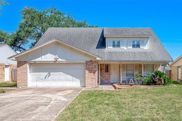 view of front of property featuring a porch, a front lawn, and a garage