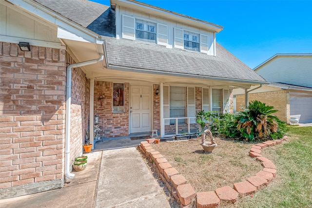 entrance to property with covered porch and a garage