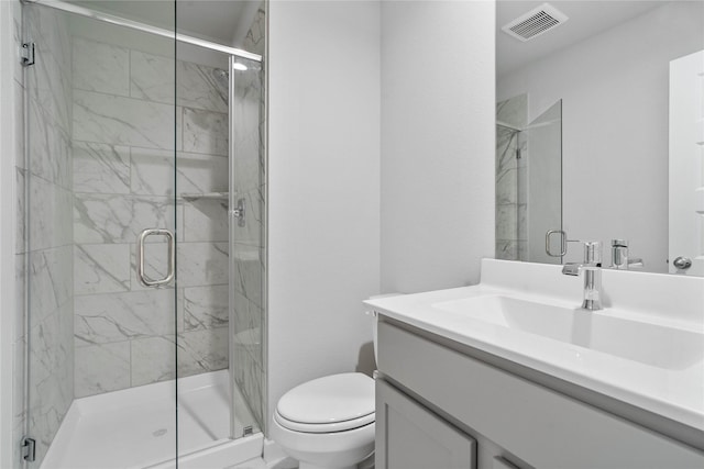 bathroom with toilet, a marble finish shower, vanity, and visible vents