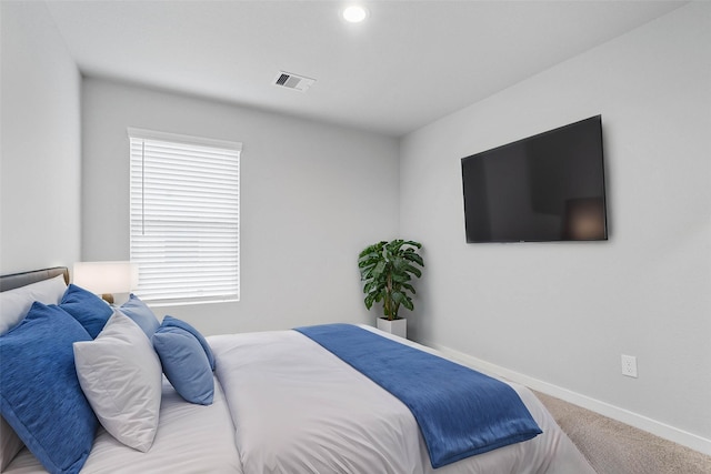 bedroom featuring carpet flooring, visible vents, and baseboards