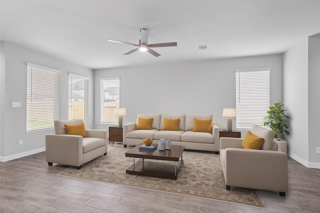 living area with ceiling fan, light wood-type flooring, visible vents, and baseboards