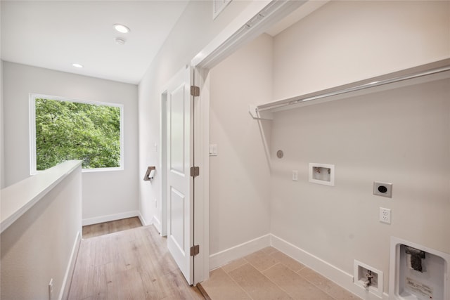 laundry room with hookup for an electric dryer, light hardwood / wood-style flooring, washer hookup, and gas dryer hookup