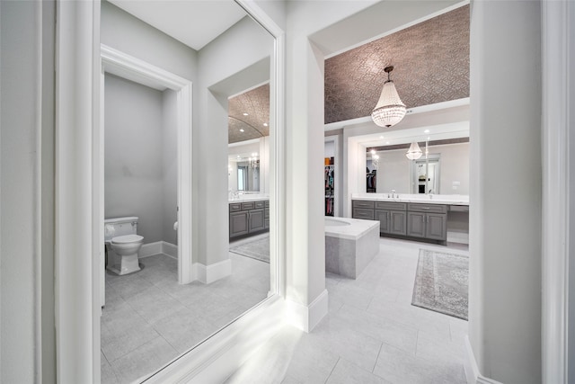 bathroom with tile patterned flooring, vanity, and toilet