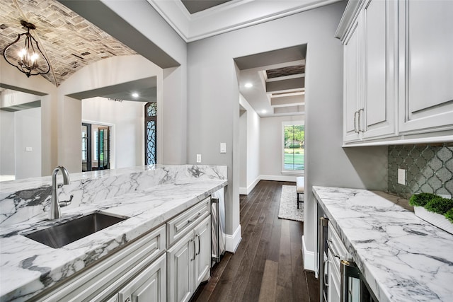 kitchen with white cabinetry, sink, beamed ceiling, dark hardwood / wood-style floors, and decorative backsplash