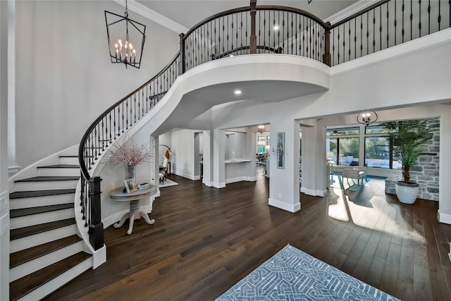 foyer entrance featuring dark hardwood / wood-style flooring and a high ceiling