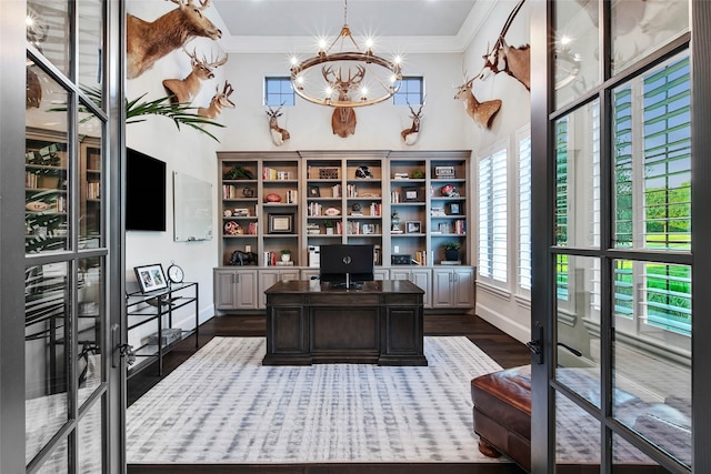 home office with a chandelier, french doors, dark hardwood / wood-style floors, and ornamental molding