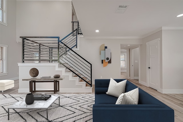 living room featuring ornamental molding, hardwood / wood-style floors, and plenty of natural light