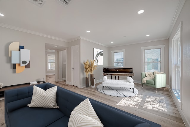 living room with a wealth of natural light, ornamental molding, and light wood-type flooring