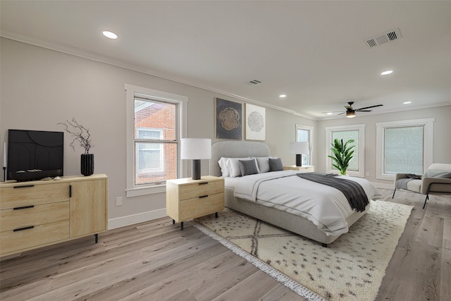 bedroom with ceiling fan, ornamental molding, and light hardwood / wood-style flooring