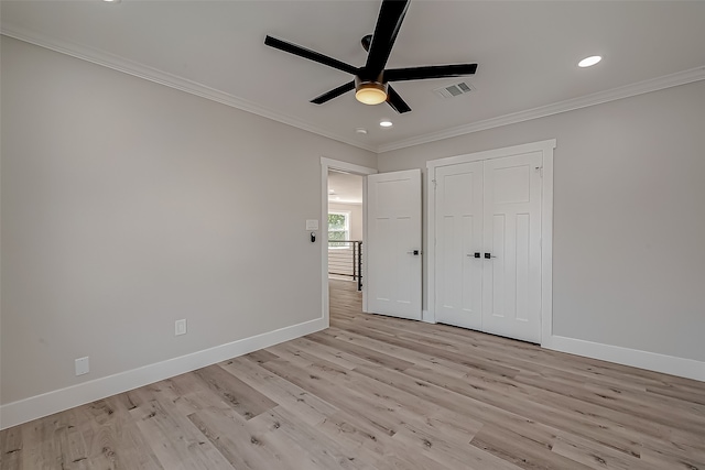 unfurnished bedroom featuring a closet, crown molding, light wood-type flooring, and ceiling fan