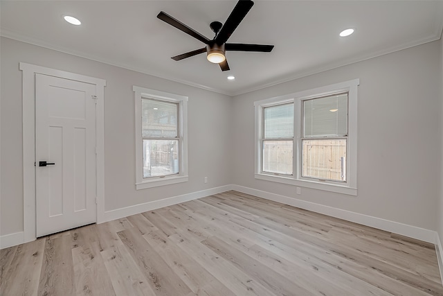 unfurnished room featuring light hardwood / wood-style floors, ornamental molding, and ceiling fan