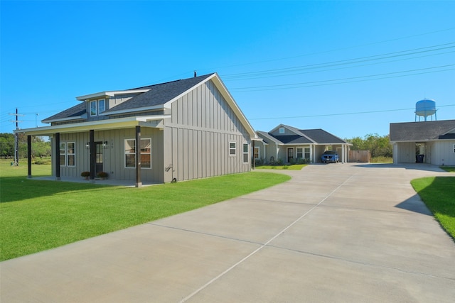 view of home's exterior featuring a porch and a yard