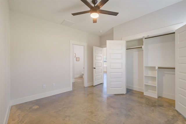 unfurnished bedroom with concrete flooring, ceiling fan, and a closet