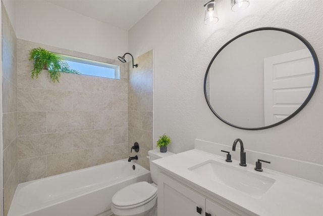 full bathroom with vanity, tiled shower / bath combo, and toilet