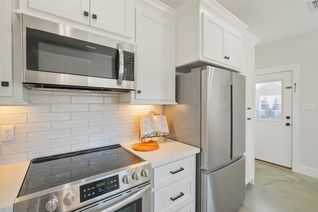 kitchen with tasteful backsplash, appliances with stainless steel finishes, and white cabinets