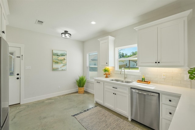 kitchen featuring white cabinetry, dishwasher, sink, and decorative backsplash