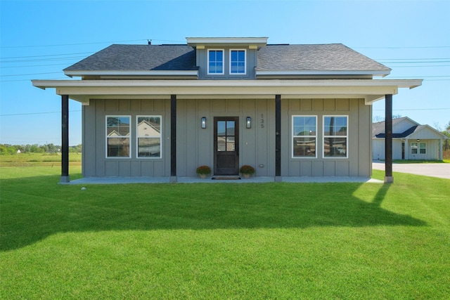 view of front of house with covered porch and a front lawn