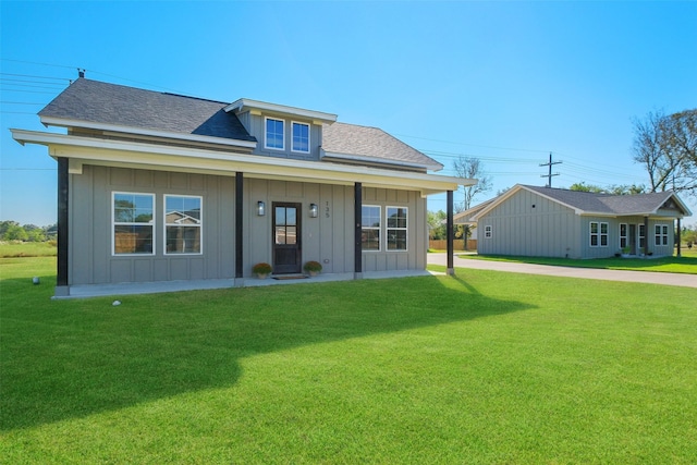 view of front of home featuring covered porch and a front yard