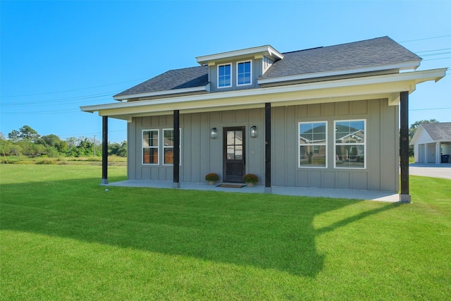 view of front facade with a front yard and covered porch