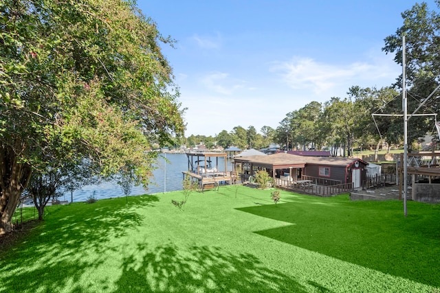 view of yard featuring a dock and a water view