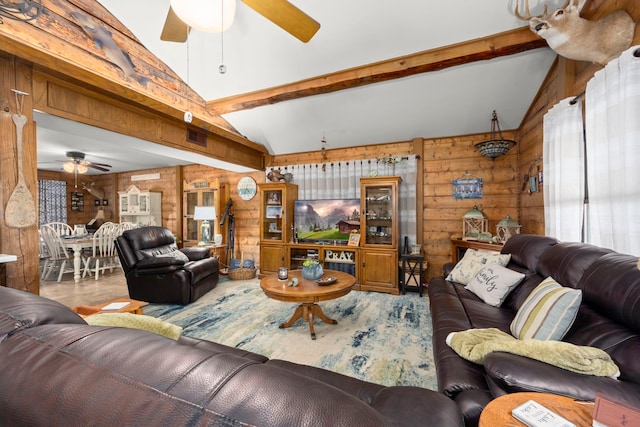 living room with wooden walls and lofted ceiling with beams