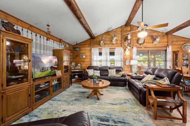 living room featuring rustic walls, ceiling fan, and vaulted ceiling with beams