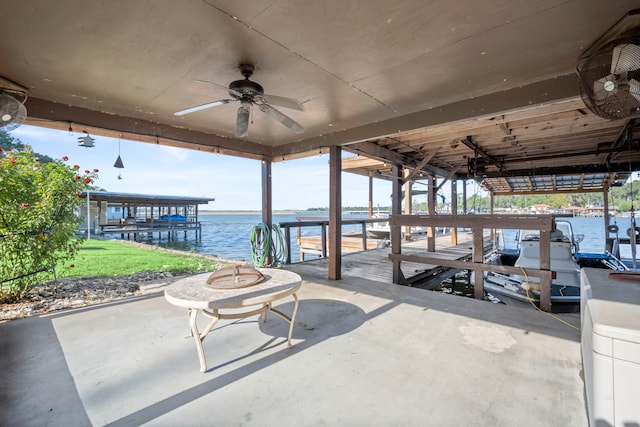 view of patio with ceiling fan, a boat dock, and a water view