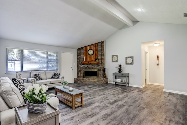 living room featuring vaulted ceiling with beams, hardwood / wood-style flooring, and a brick fireplace