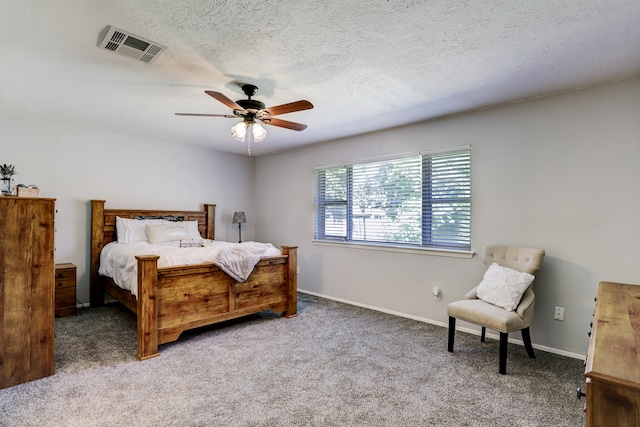 bedroom featuring carpet floors, a textured ceiling, and ceiling fan