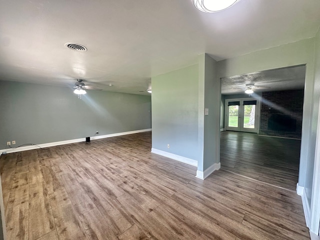 additional living space with hardwood / wood-style floors, french doors, and ceiling fan