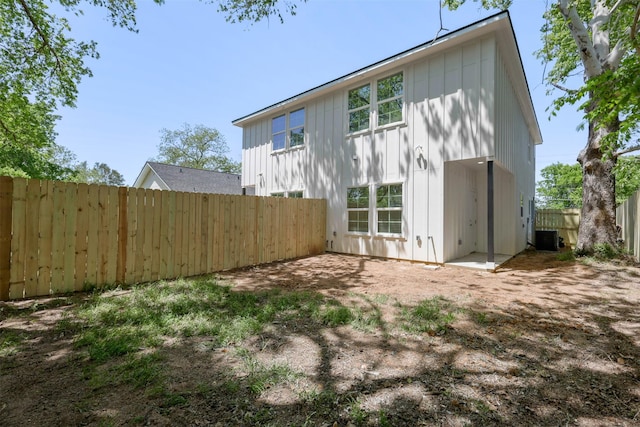 1310 E Alamo St A-B, Unit A-B Brenham, TX 77833 - view of side of property featuring cooling unit, board and batten siding, and fence
