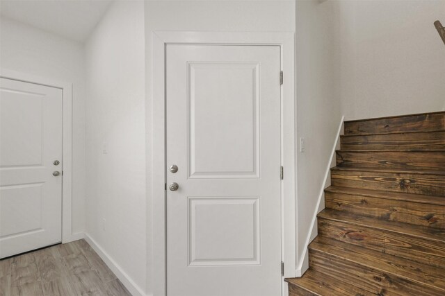 1310 E Alamo St A-B, Unit A-B Brenham, TX 77833 - staircase with baseboards and wood finished floors