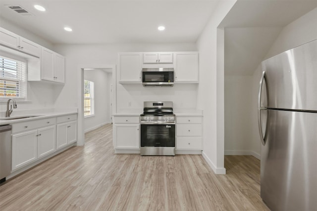 1310 E Alamo St A-B, Unit A-B Brenham, TX 77833 - kitchen with baseboards, light countertops, a sink, and appliances with stainless steel finishes
