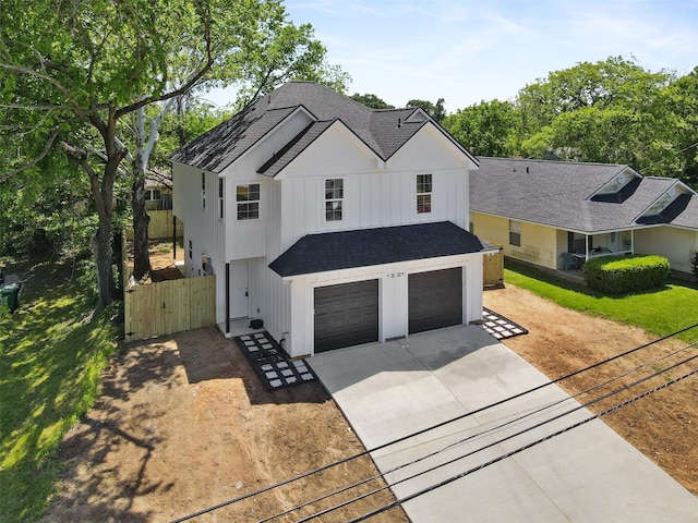 1310 E Alamo St A-B, Unit A-B Brenham, TX 77833 - modern farmhouse with a shingled roof, a garage, board and batten siding, fence, and driveway